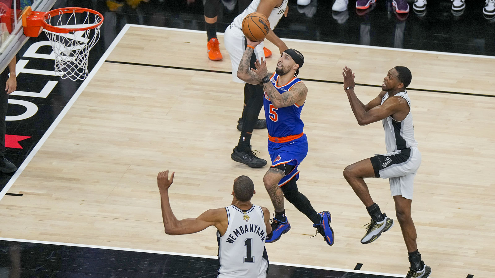 New York Knicks guard Jose Alvarado (5) drives to the basket past San Antonio Spurs forward Victor Wembanyama (1) during the fourth quarter during game five of the 2026 NBA Finals at Frost Bank Center. 