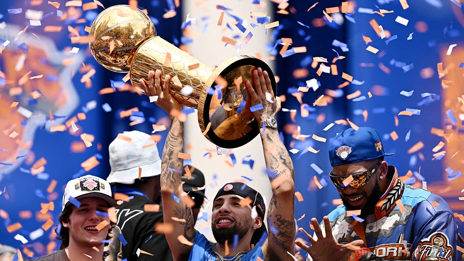 New York Knicks' Jose Alvarado celebrates with Tyler Kolek, Karl-Anthony Towns and the Larry O'Brien Championship Trophy at New York City Hall during the parade.