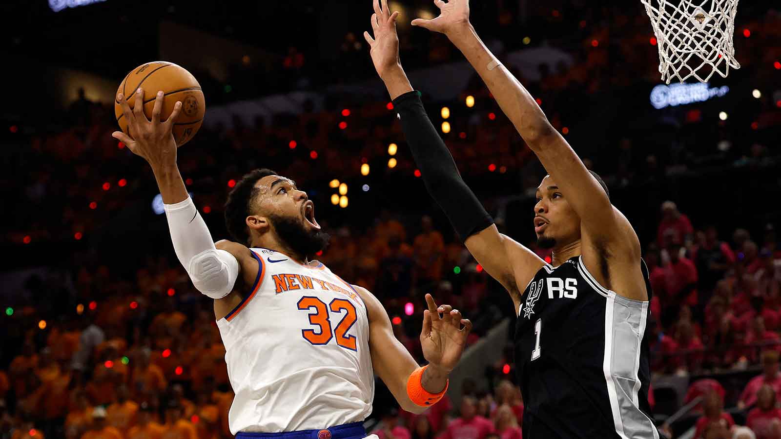 Knicks center Karl-Anthony Towns (32) shoots the ball past San Antonio Spurs forward Victor Wembanyama (1) in the first half during game one of the 2026 NBA Finals at Frost Bank Center