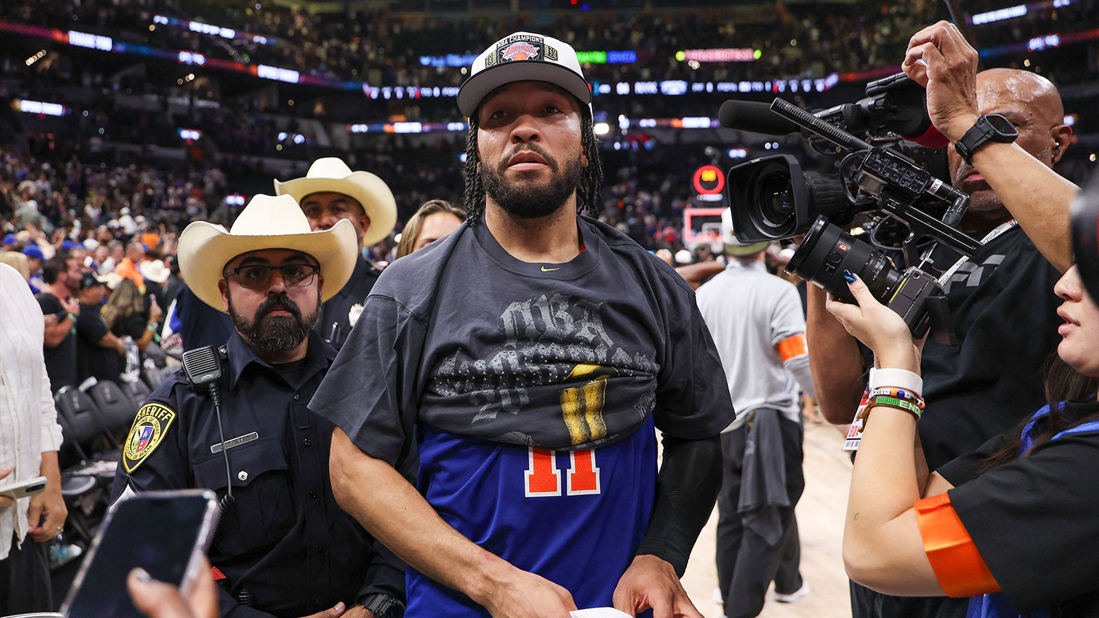 Knicks guard Jalen Brunson (11) walks to the end of the court prior to the championship trophy celebration after game five of the 2026 NBA Finals against the San Antonio Spurs at Frost Bank Center