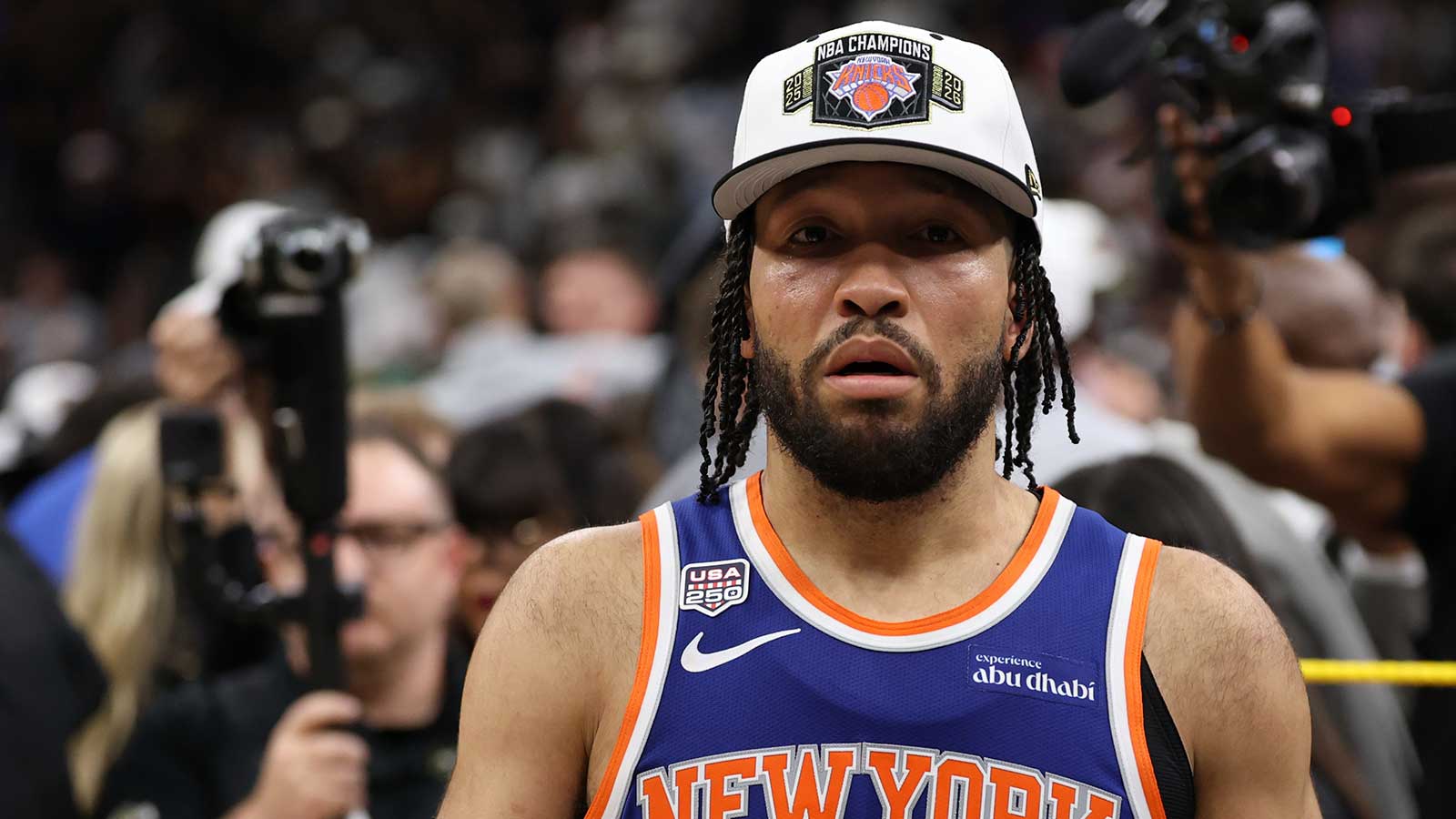 Knicks guard Jalen Brunson (11) walks to the end of the court prior to the championship trophy celebration after game five of the 2026 NBA Finals against the San Antonio Spurs at Frost Bank Center