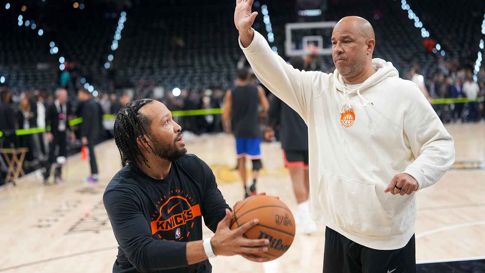 New York Knicks assistant coach Rick Brunson warms up with guard Jalen Brunson (11) before the game between the San Antonio Spurs and the New York Knicks in game two of the 2026 NBA Finals at Frost Bank Center.