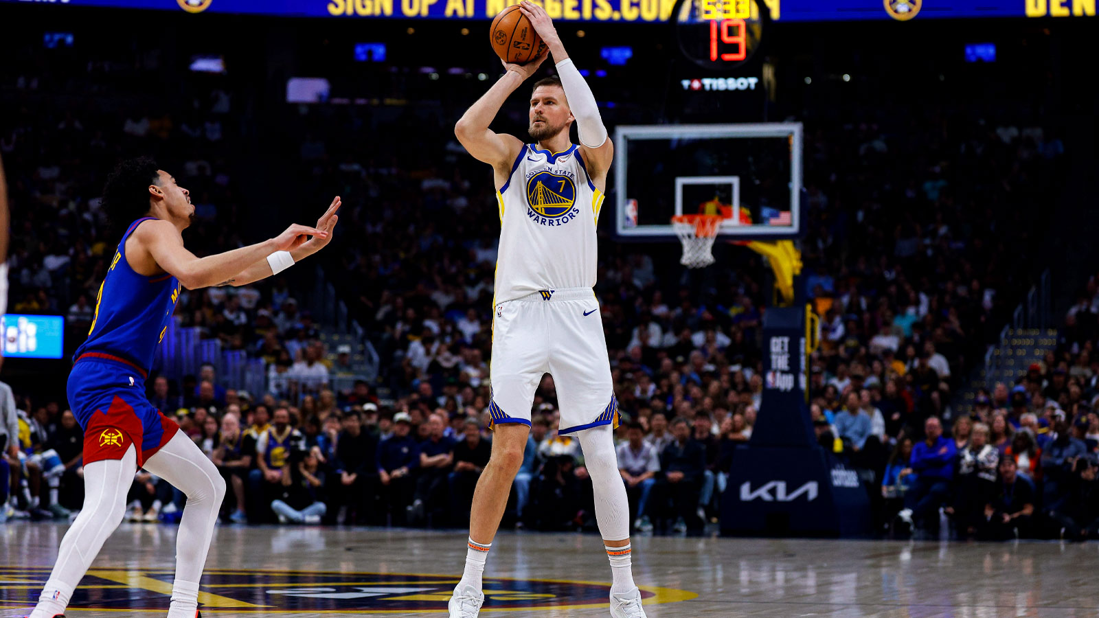 Golden State Warriors center Kristaps Porzingis (7) attempts a shot as Denver Nuggets guard Julian Strawther (3) defends in the second quarter at Ball Arena. 