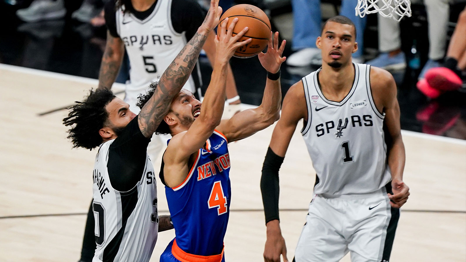 New York Knicks guard Landry Shamet (44) shoots past San Antonio Spurs forward Julian Champagnie (30) in the second half during game five of the 2026 NBA Finals at Frost Bank Center. 