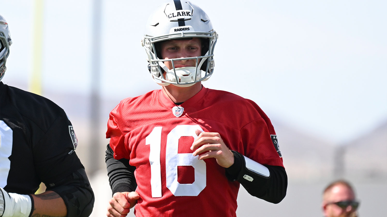 Las Vegas Raiders quarterback Jacob Clark (16) warms up during organized team activities