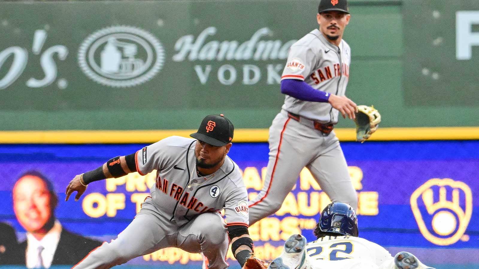 Milwaukee Brewers designated hitter Christian Yelich (22) steals second base as San Francisco Giants second baseman Luis Arraez (1) waits for the ball in the first inning at American Family Field. 
