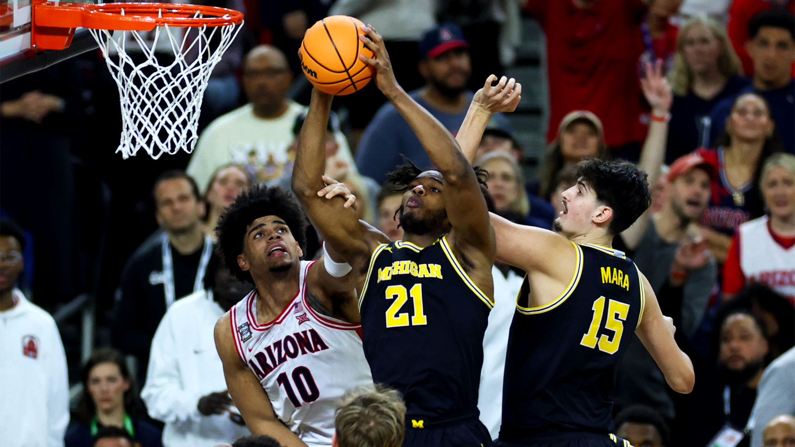 In Text: Michigan Wolverines Morez Johnson Jr. rebounds the ball against Arizona Wildcats Koa Peat