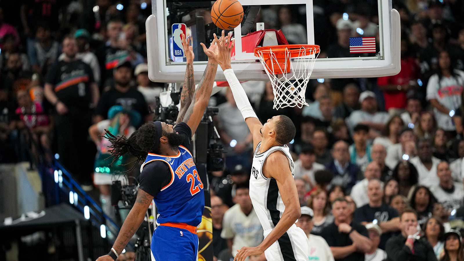 New York Knicks center Mitchell Robinson (23) and San Antonio Spurs forward Victor Wembanyama (1) battle for the ball during the fourth quarter during game two of the 2026 NBA Finals at Frost Bank Center. 