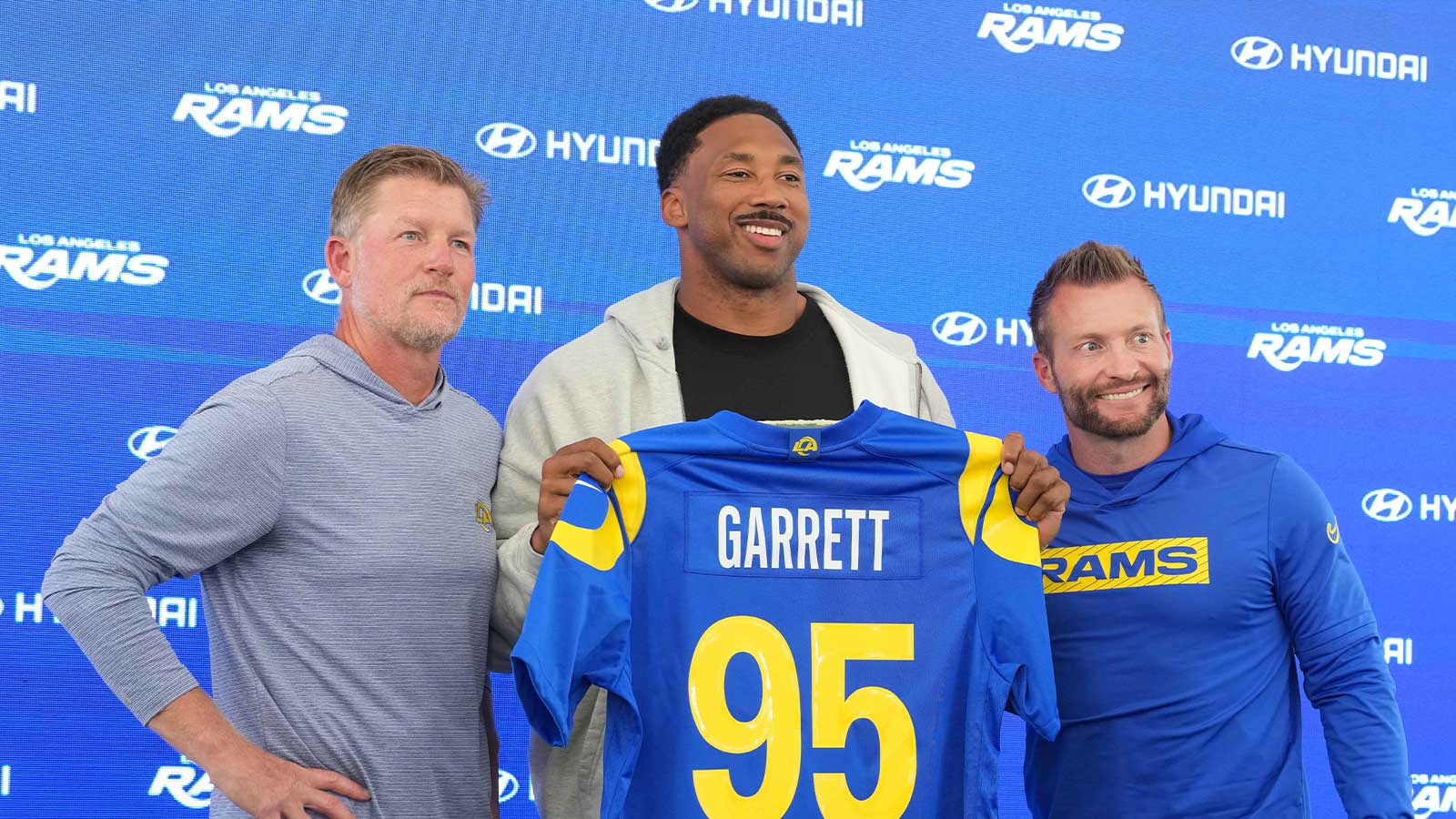 Los Angeles Rams defensive end Myles Garrett (95) poses with general manager Les Snead (left) and coach Sean McVay at press conference at Rams Practice Facility.