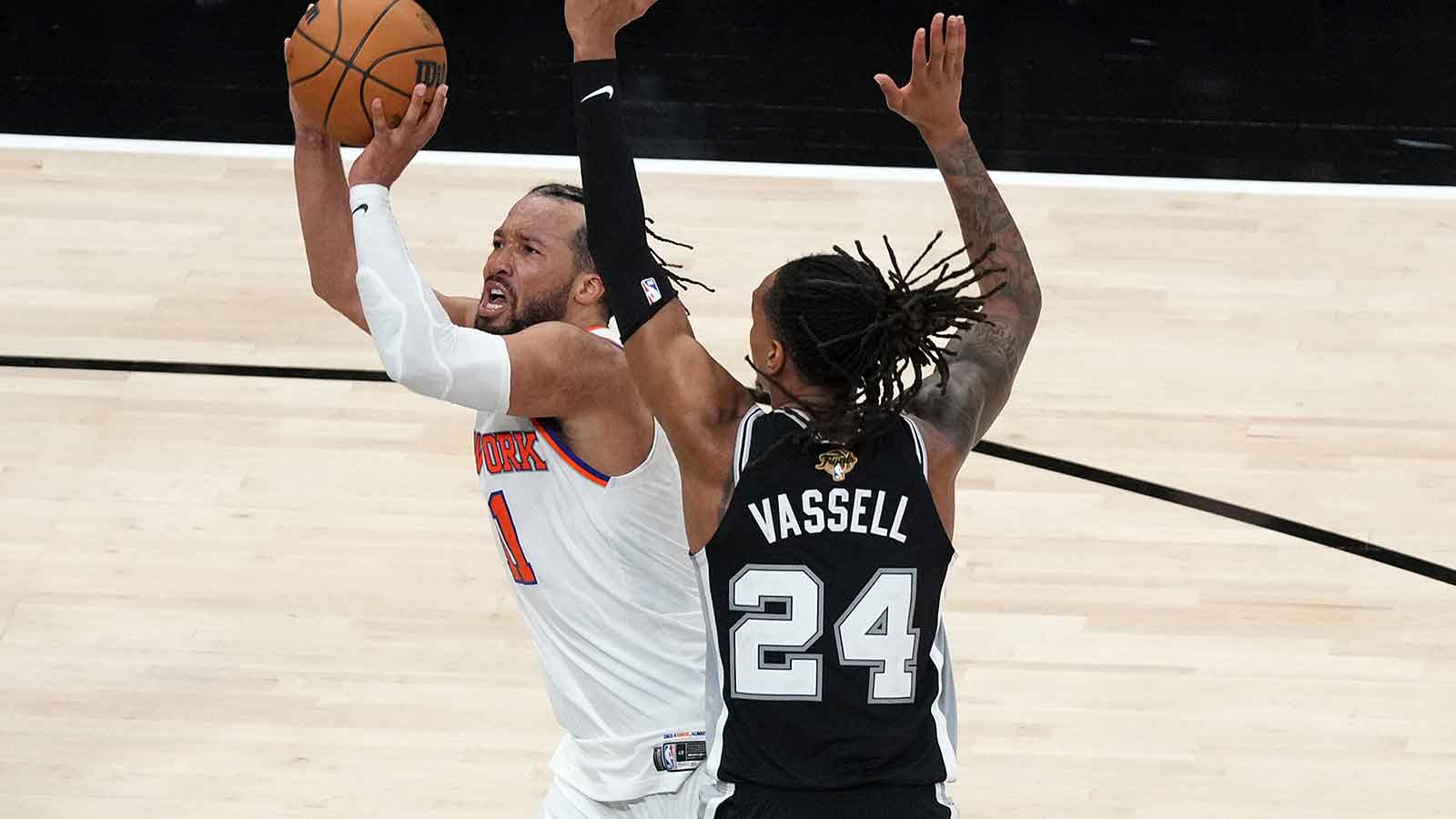 New York Knicks guard Jalen Brunson (11) shoots the ball over San Antonio Spurs guard Devin Vassell (24) in the second half during game one of the 2026 NBA Finals at Frost Bank Center.