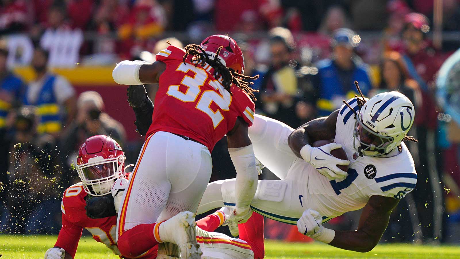 Kansas City Chiefs linebacker Nick Bolton (32) and cornerback Chris Roland-Wallace (30) tackle Indianapolis Colts tight end Mo Alie-Cox (81) in the first half at GEHA Field at Arrowhead Stadium. 