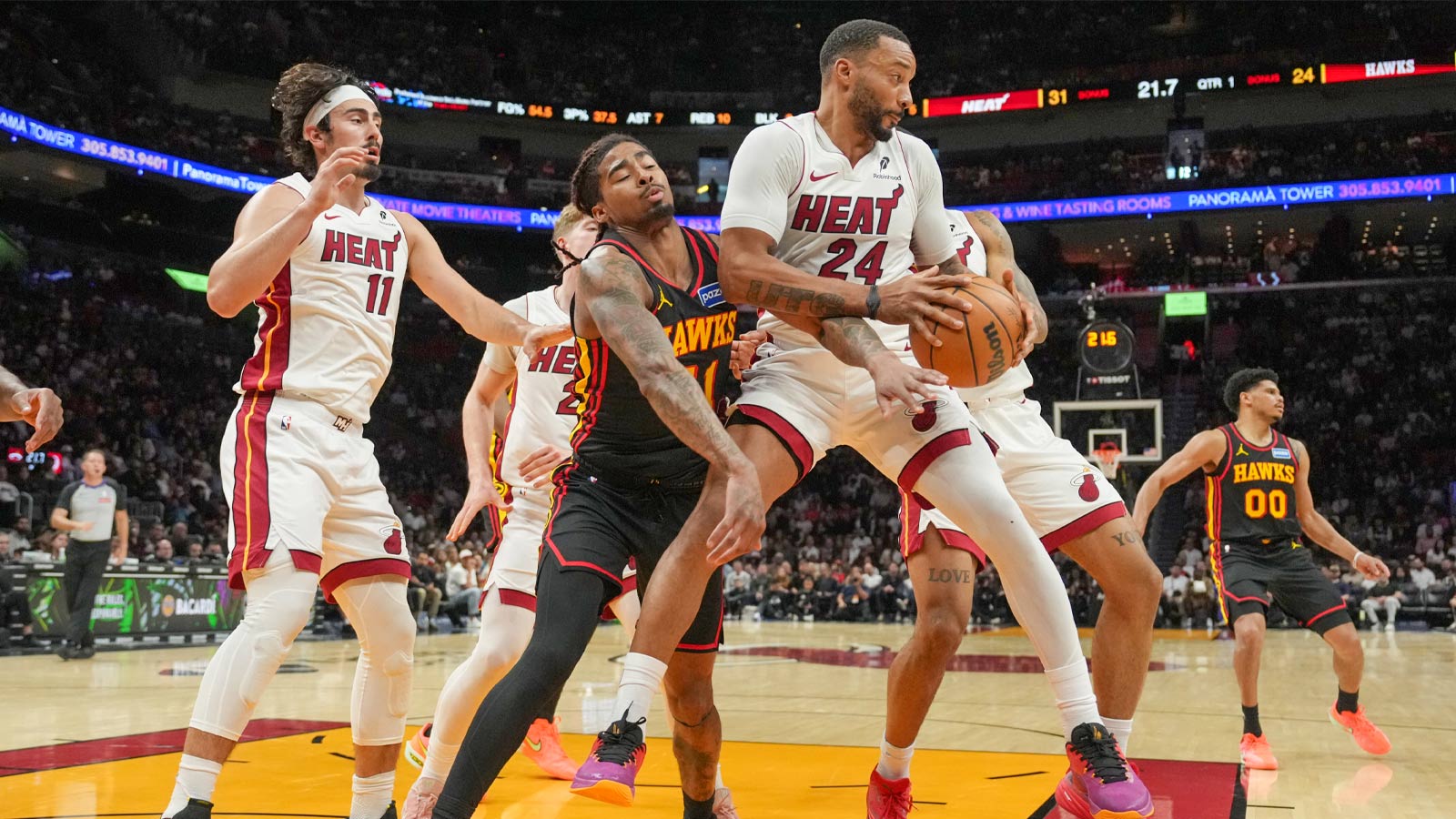 Miami Heat guard Norman Powell (24) grabs a rebound in front of Atlanta Hawks guard Keshon Gilbert (51) during the first half at Kaseya Center. 