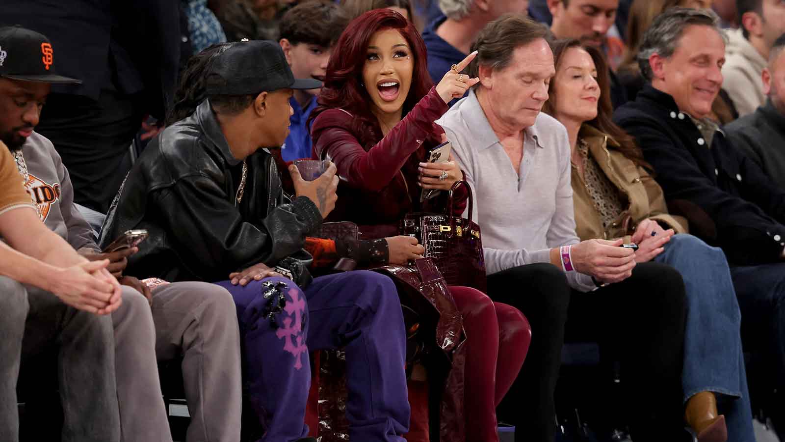 rapper Cardi B (center) talks to rapper A Boogie Wit da Hoodie (left) during the third quarter between the New York Knicks and the Milwaukee Bucks at Madison Square Garden