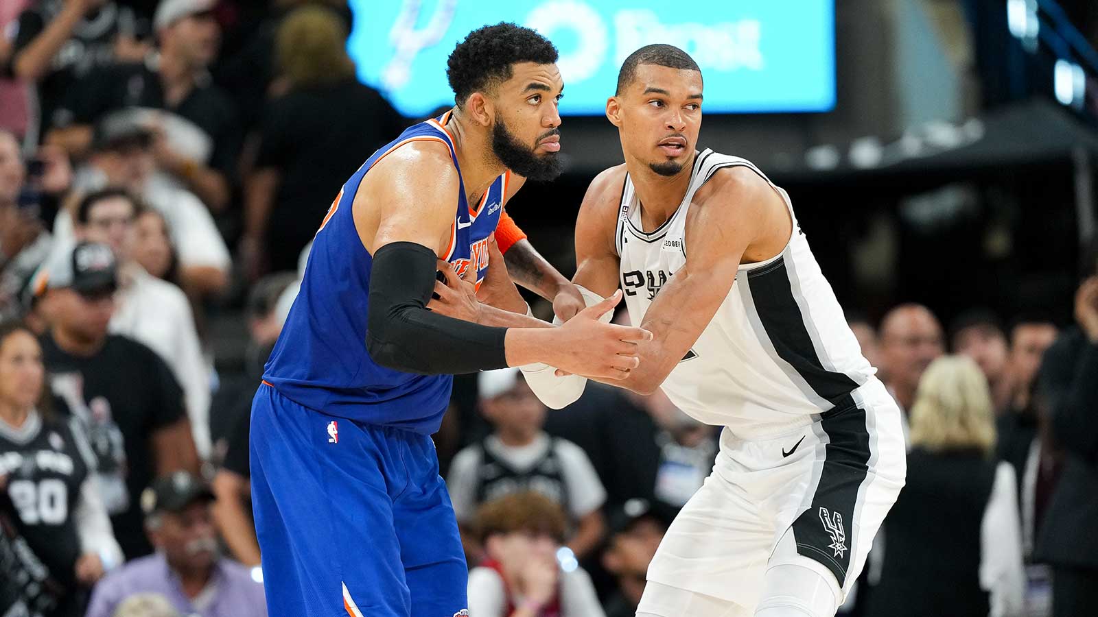 New York Knicks center Karl-Anthony Towns (32) and San Antonio Spurs forward Victor Wembanyama (1) look for the ball in the second half during game two of the 2026 NBA Finals at Frost Bank Center.