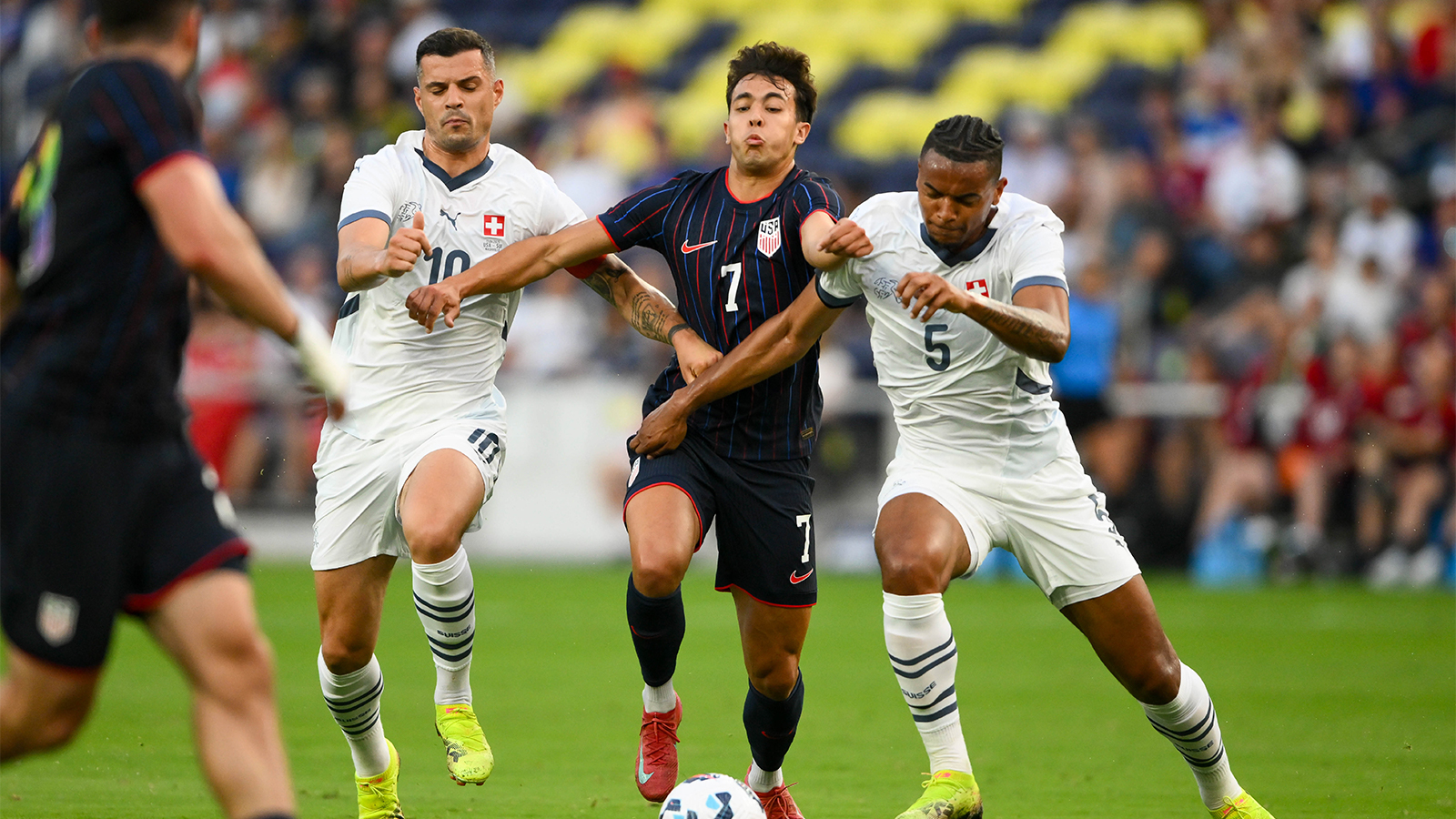 Switzerland midfielder Granit Xhaka (10) and defender Manuel Akanji (5) fights for the ball with United States forward Quinn Sullivan (7) during the first at Geodis Park. 