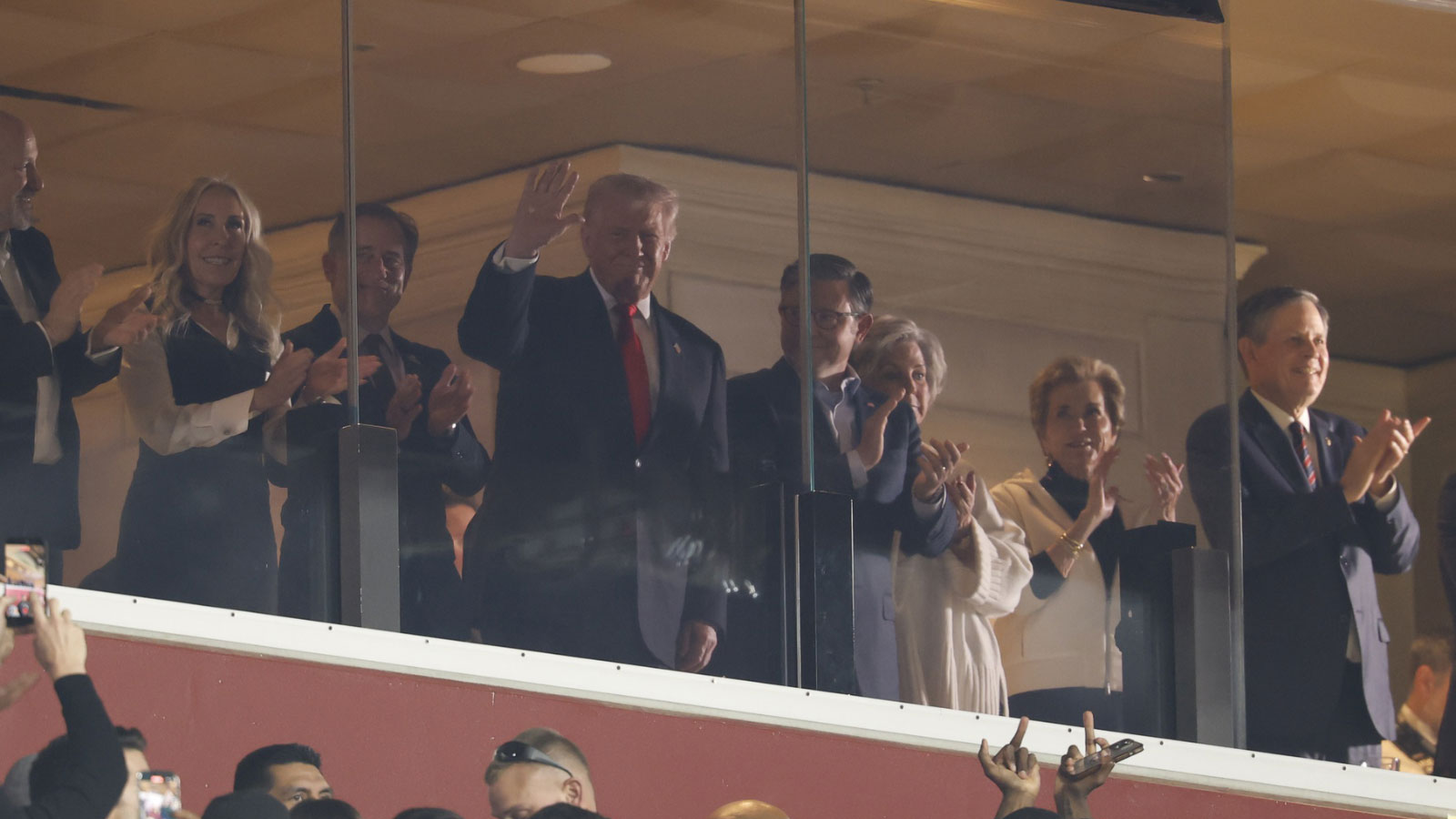 President Donald Trump waves from the Washington Commanders owners box during the second quarter of a game between the Detroit Lions and the Washington Commanders at Northwest Stadium