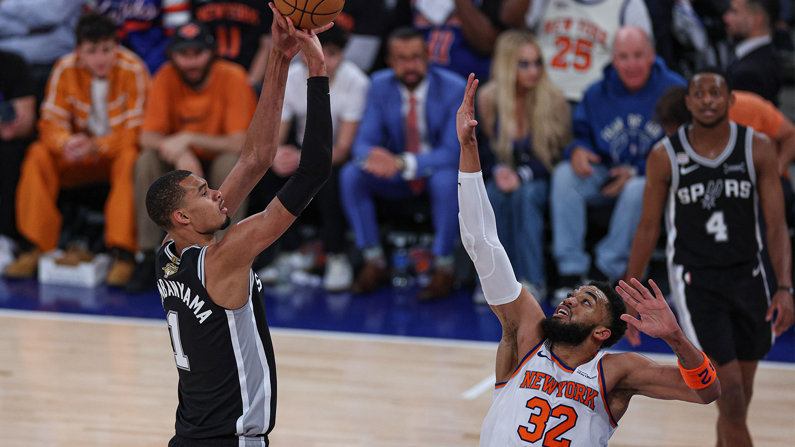 San Antonio Spurs forward Victor Wembanyama (1) shoots the ball as New York Knicks center Karl-Anthony Towns (32) defends during game three of the 2026 NBA Finals at Madison Square Garden.