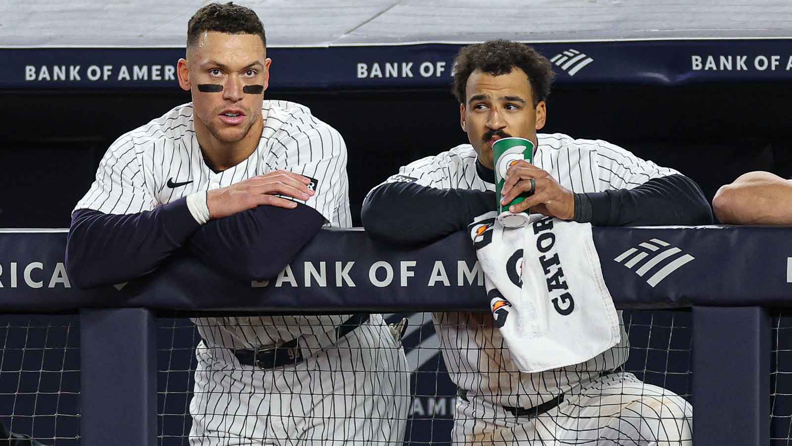 New York Yankees right fielder Aaron Judge (99) and center fielder Trent Grisham (12) look out from the dugout during the fifth inning against the Baltimore Orioles at Yankee Stadium.