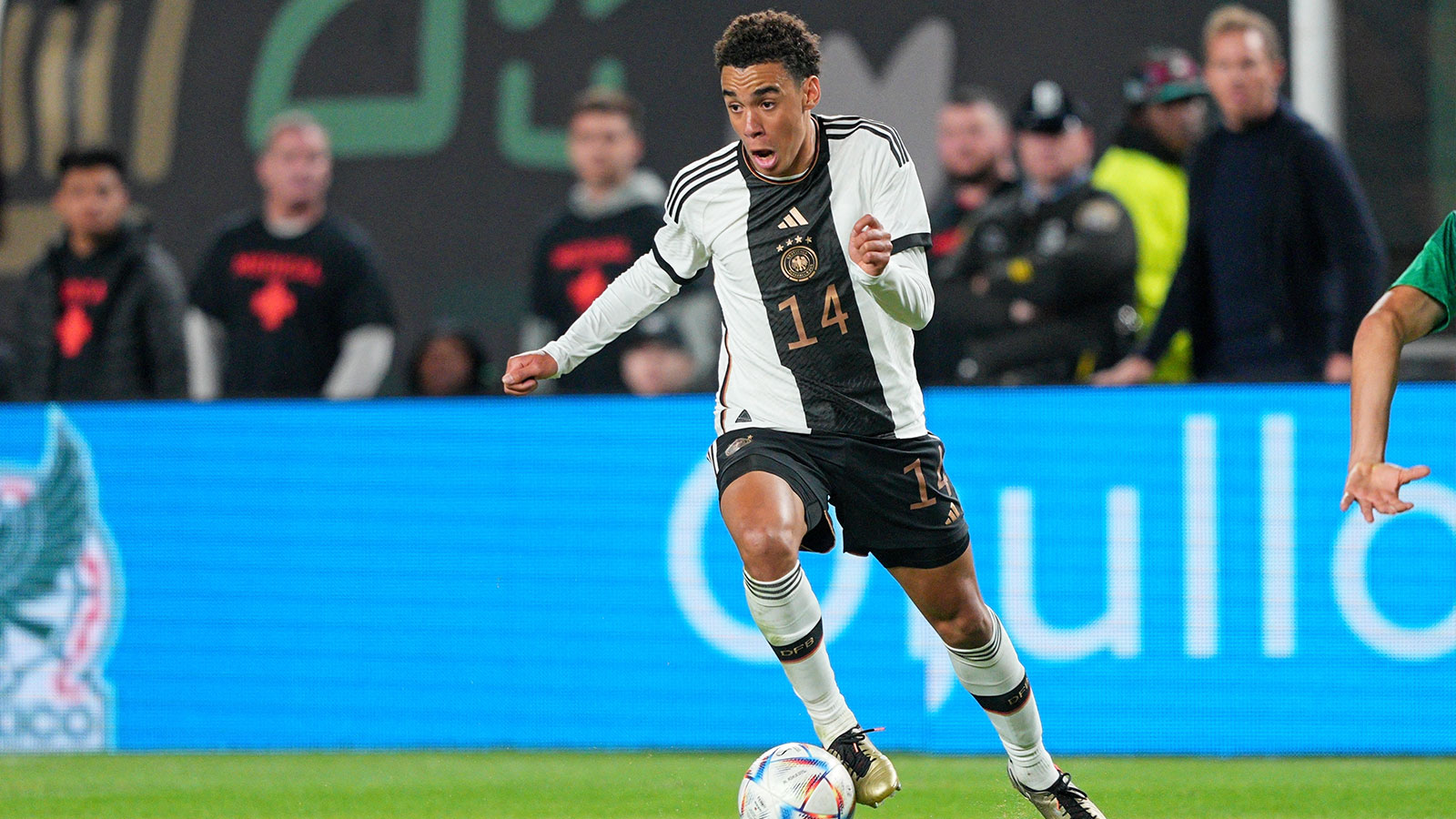 Germany midfielder Jamal Musiala (14) dribbles the ball against Mexico during the second half at Lincoln Financial Field. 