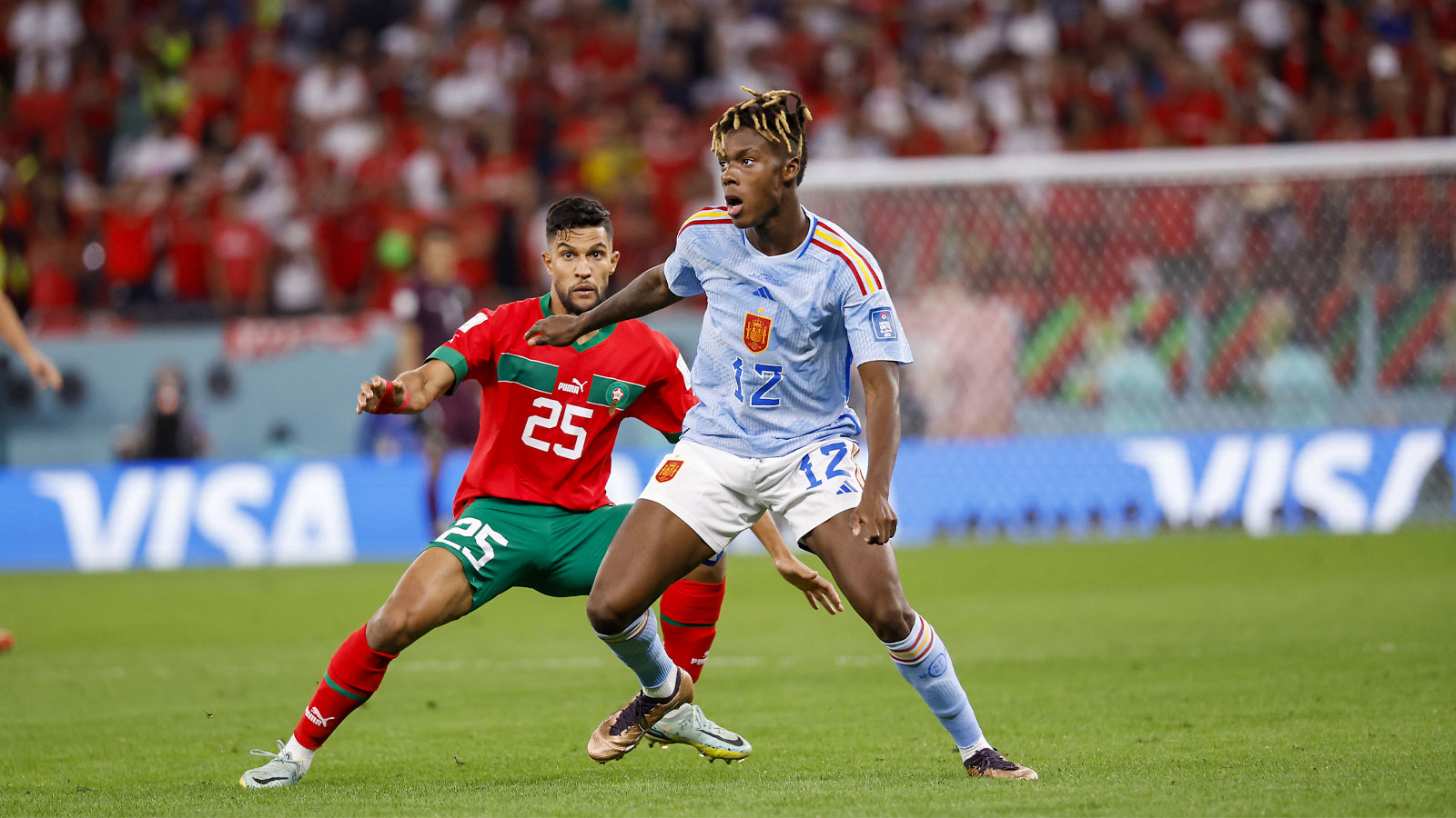 Spain forward Nico Williams (12) controls the ball against Morocco defender Yahia Attiyat Allah (25) during the second half in the round of sixteen match of the 2022 FIFA World Cup at Education City Stadium.