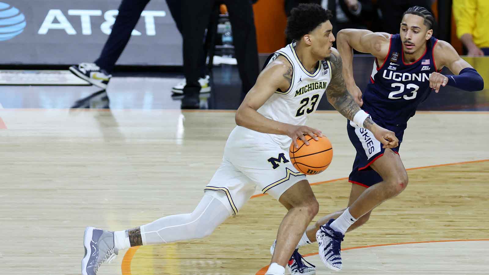 Michigan Wolverines forward Yaxel Lendeborg (23) dribbles the ball against UConn Huskies forward Jayden Ross (23) in the second half during the national championship of the Final Four of the men's 2026 NCAA Tournament at Lucas Oil Stadium.