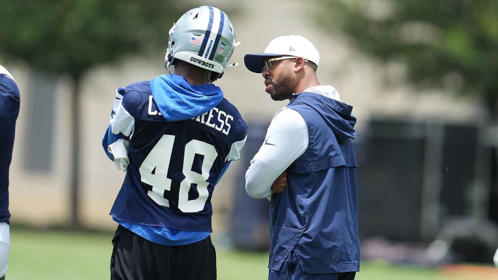 Dallas Cowboys defensive coordinator Christian Parker speaks with cornerback Zion Childress (48) during practice at the Ford Center at the Star Training Facility in Frisco, Texas.