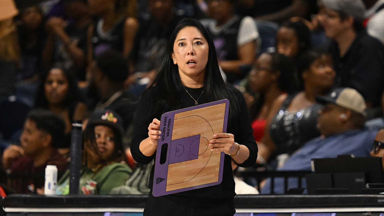 Golden State Valkyries head coach Natalie Nakase holds a clipboard against the Washington Mystics during the fourth quarter at CareFirst Arena.