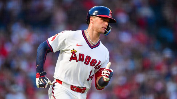 Los Angeles Angels catcher Logan O'Hoppe (14) runs after hitting a single against the Detroit Tigers during the third inning at Angel Stadium.