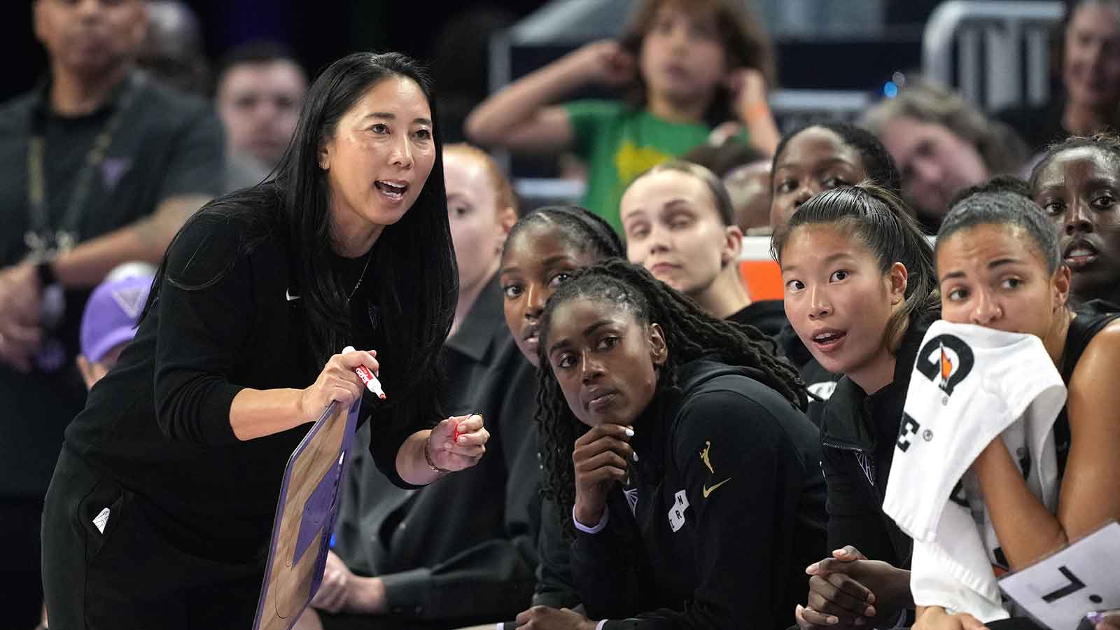 Golden State Valkyries head coach Natalie Nakase (left) talks to players during the third quarter against the Washington Mystics at Chase Center.