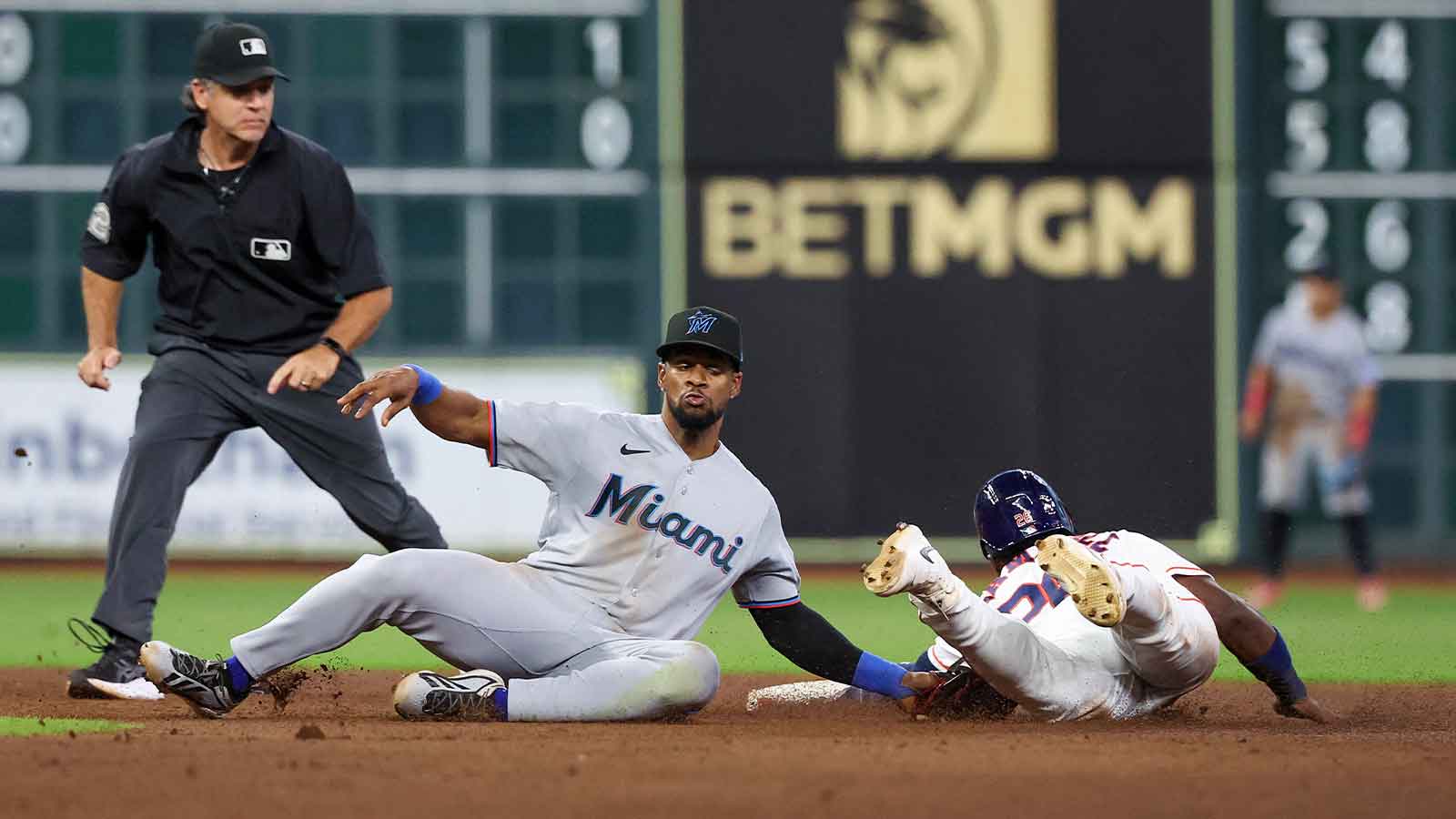 Houston Astros right fielder Taylor Trammell (26) is tagged out by Miami Marlins shortstop Otto Lopez (6) while trying to steal second base in the fourth inning inning at Daikin Park. 