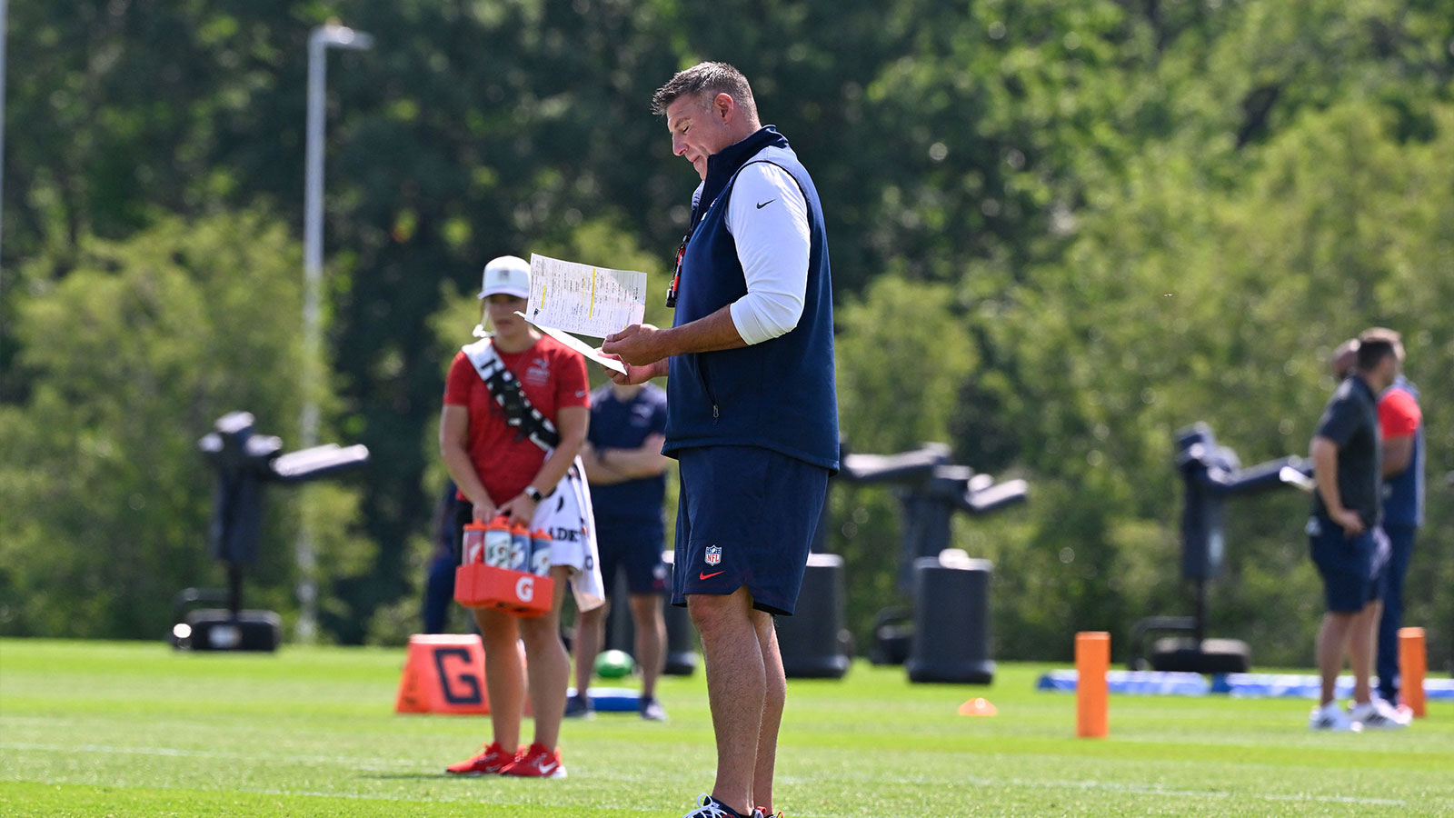 New England Patriots head coach Mike Vrabel looks over notes at training camp at Gillette Stadium.