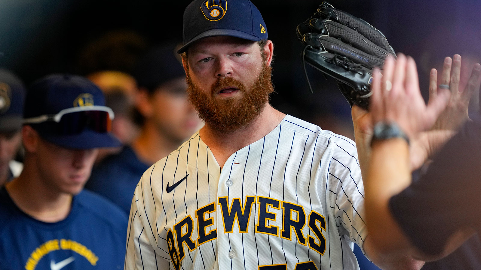 Milwaukee Brewers pitcher Brandon Woodruff (53) high fives teammates in the dugout during the sixth inning against the Chicago Cubs at American Family Field.