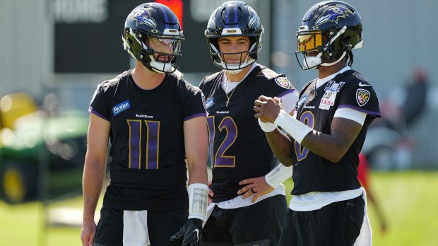 Baltimore Ravens quarterbacks Lamar Jackson (8), Joe Fagnano (12) and Skylar Thompson (11) talk during practice at Under Armour Peformance Center