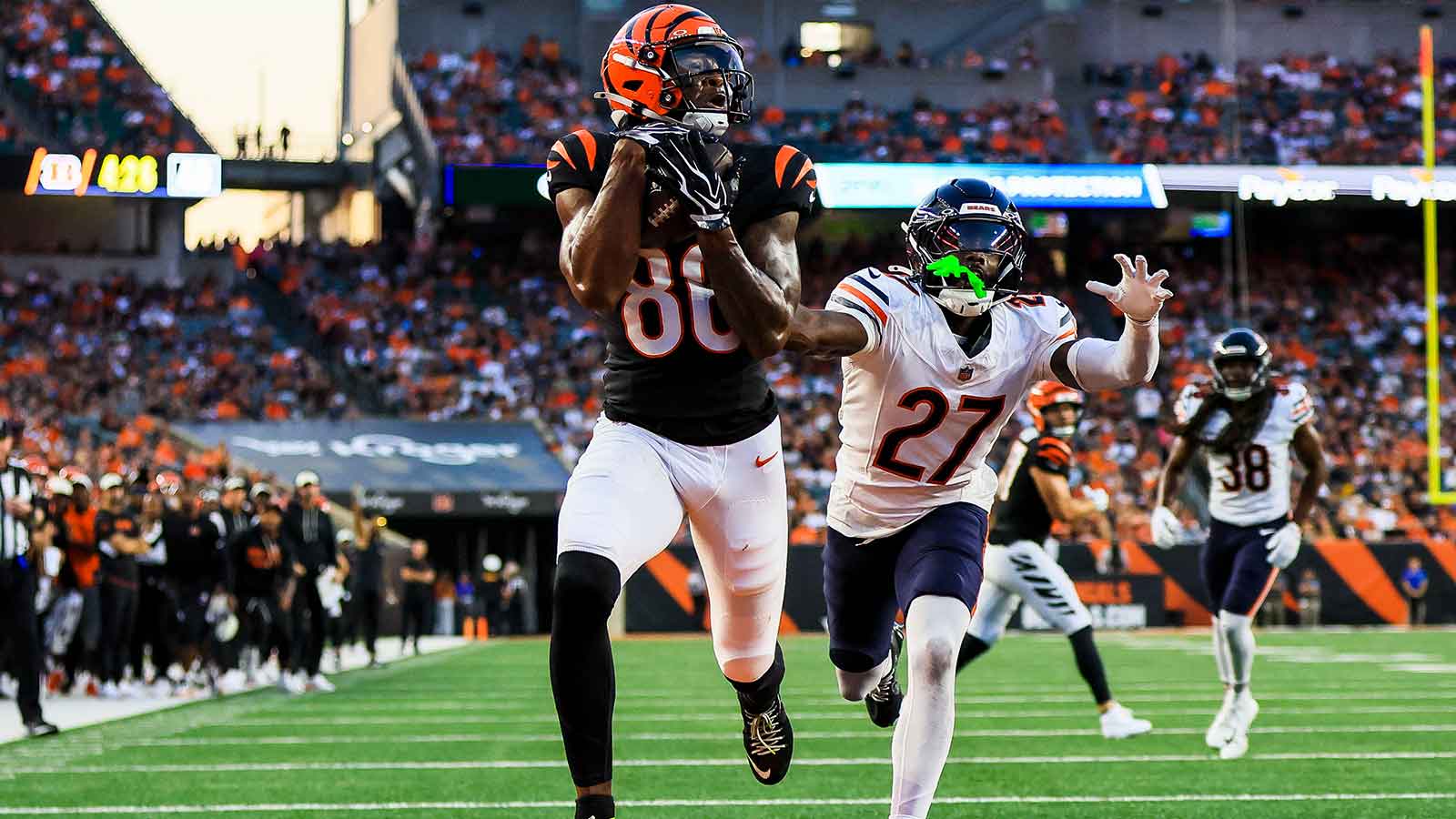 Cincinnati Bengals wide receiver Colbie Young (86) catches a pass for a touchdown against Chicago Bears cornerback Dontae Manning (27) in the first half at Paycor Stadium