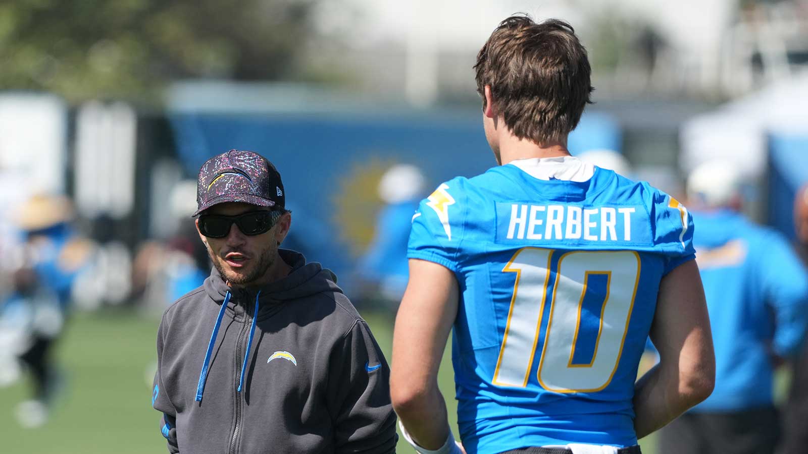 Los Angeles Chargers offensive coordinator Mike McDaniel (left) and quarterback Justin Herbert (10) during training camp at The Bolt.