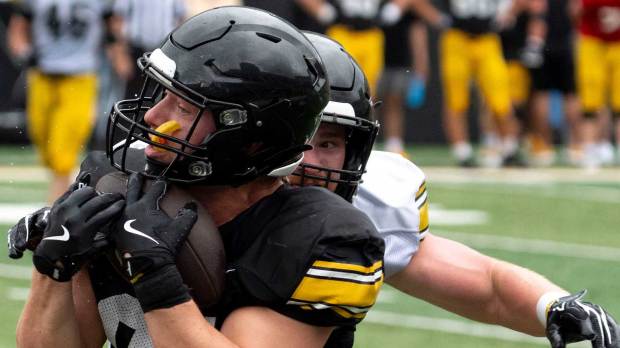 Iowa tight end DJ Vonnahme (81) catches the football as Iowa linebacker Jack Laughlin (47) defends Aug. 15, 2026 during the Kids Day at Kinnick open practice at Kinnick Stadium in Iowa City, Iowa.