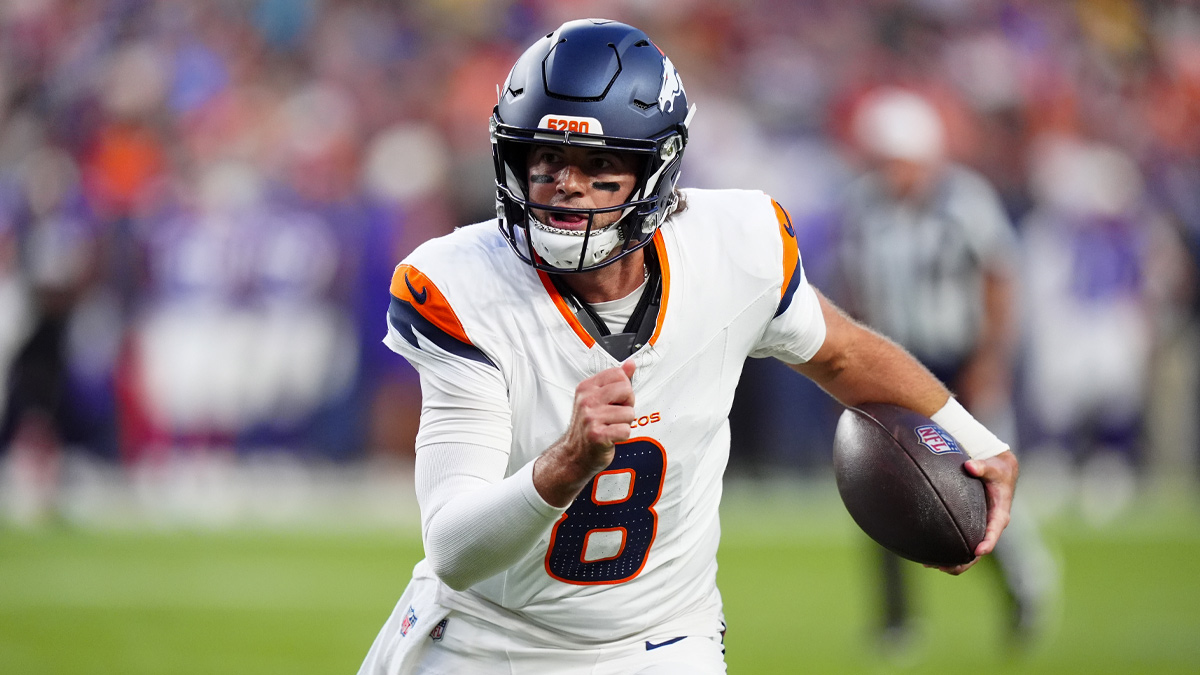 Denver Broncos quarterback Jarrett Stidham (8) scrambles with the ball in the first quarter during a preseason game against the Minnesota Vikings at Empower Field at Mile High.