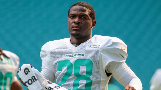 Miami Dolphins running back De'von Achane (28) looks on from the field during practice at Hard Rock Stadium.