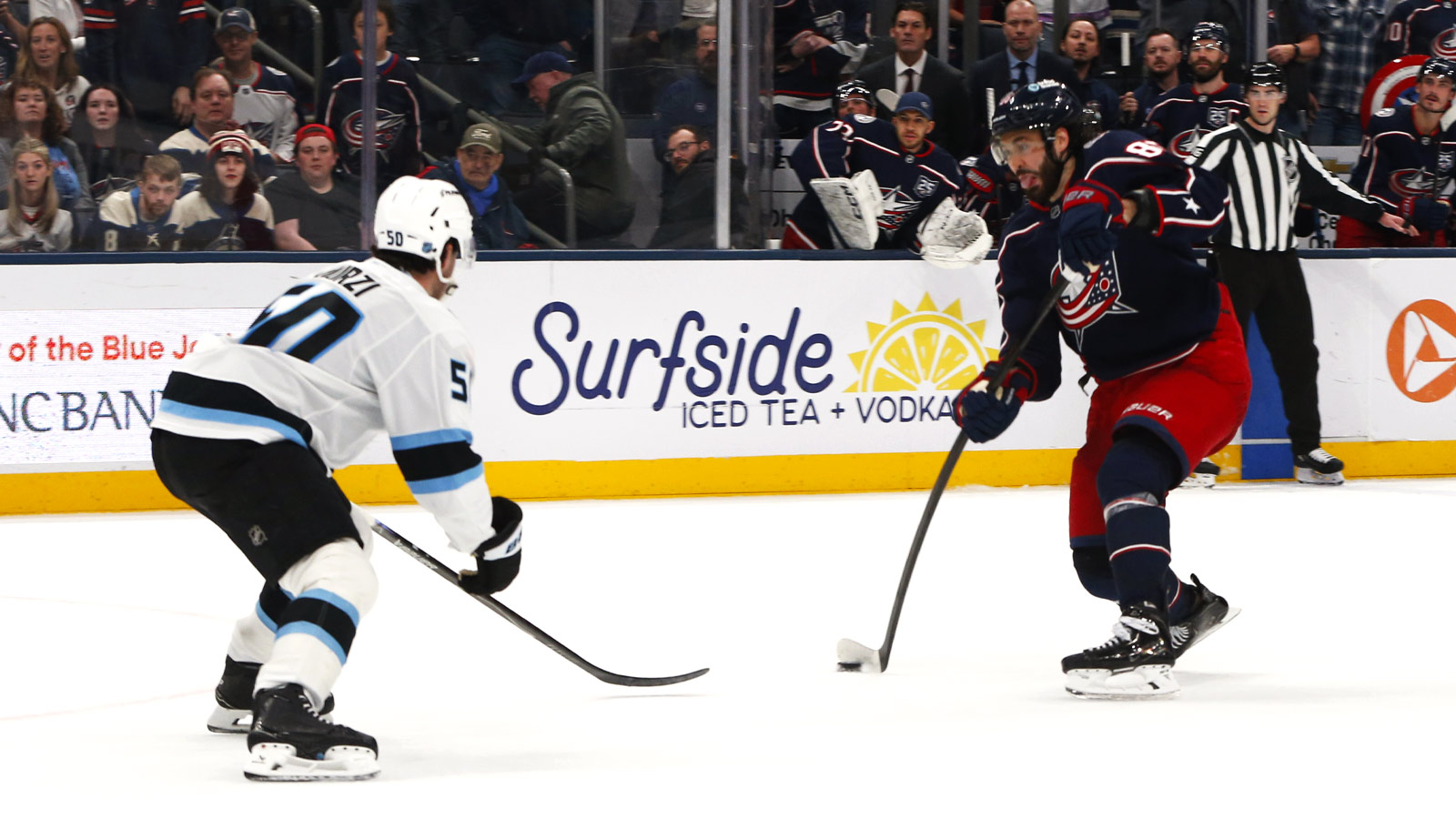 Columbus Blue Jackets right wing Kirill Marchenko (86) wrists a shot on goal as Utah Mammoth defenseman Sean Durzi (50) defends during overtime at Nationwide Arena. 