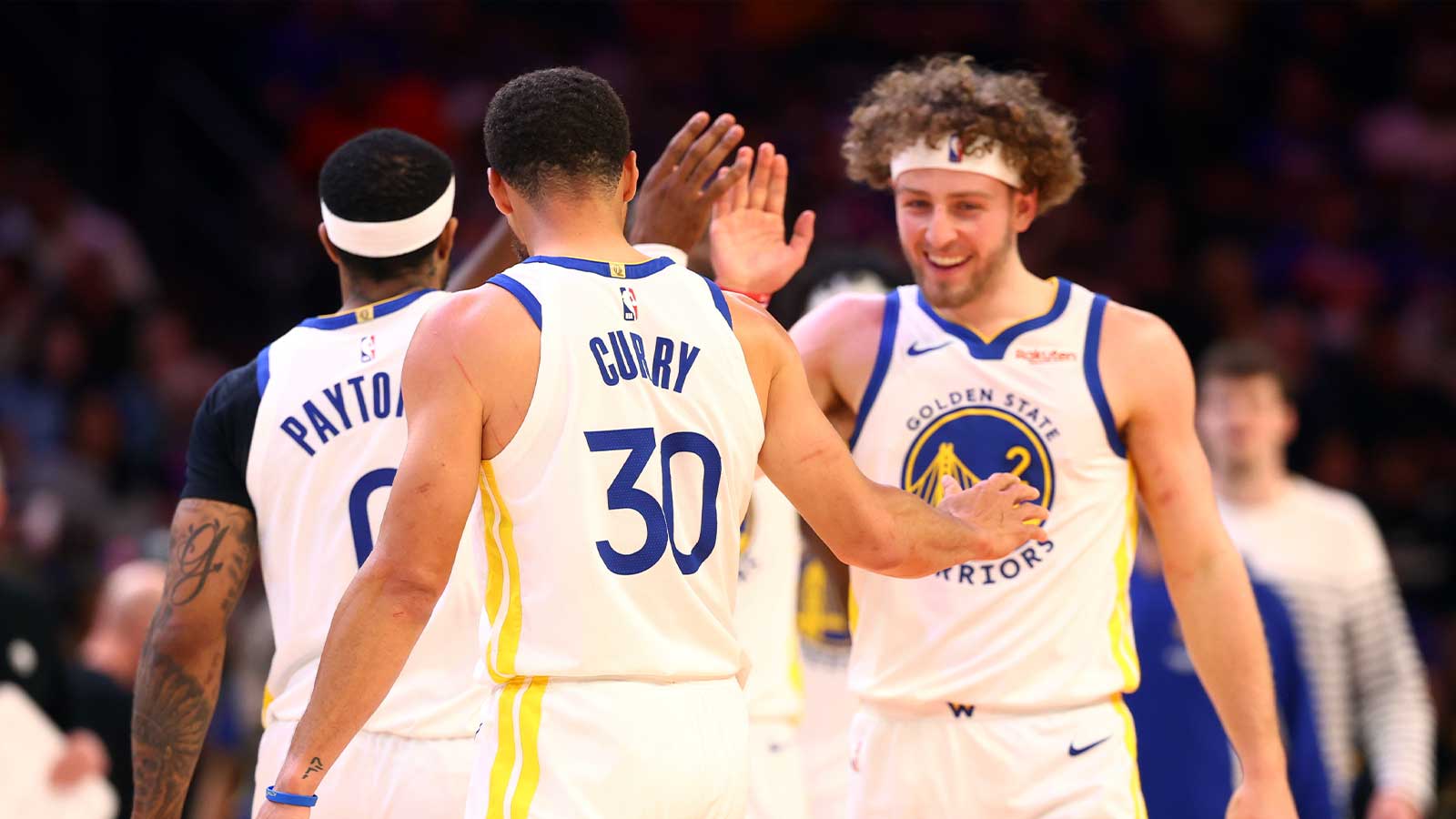 Golden State Warriors guard Stephen Curry (30) celebrates with Brandin Podziemski (2) against the Phoenix Suns during the play-in rounds of the 2026 NBA Playoffs at Mortgage Matchup Center.