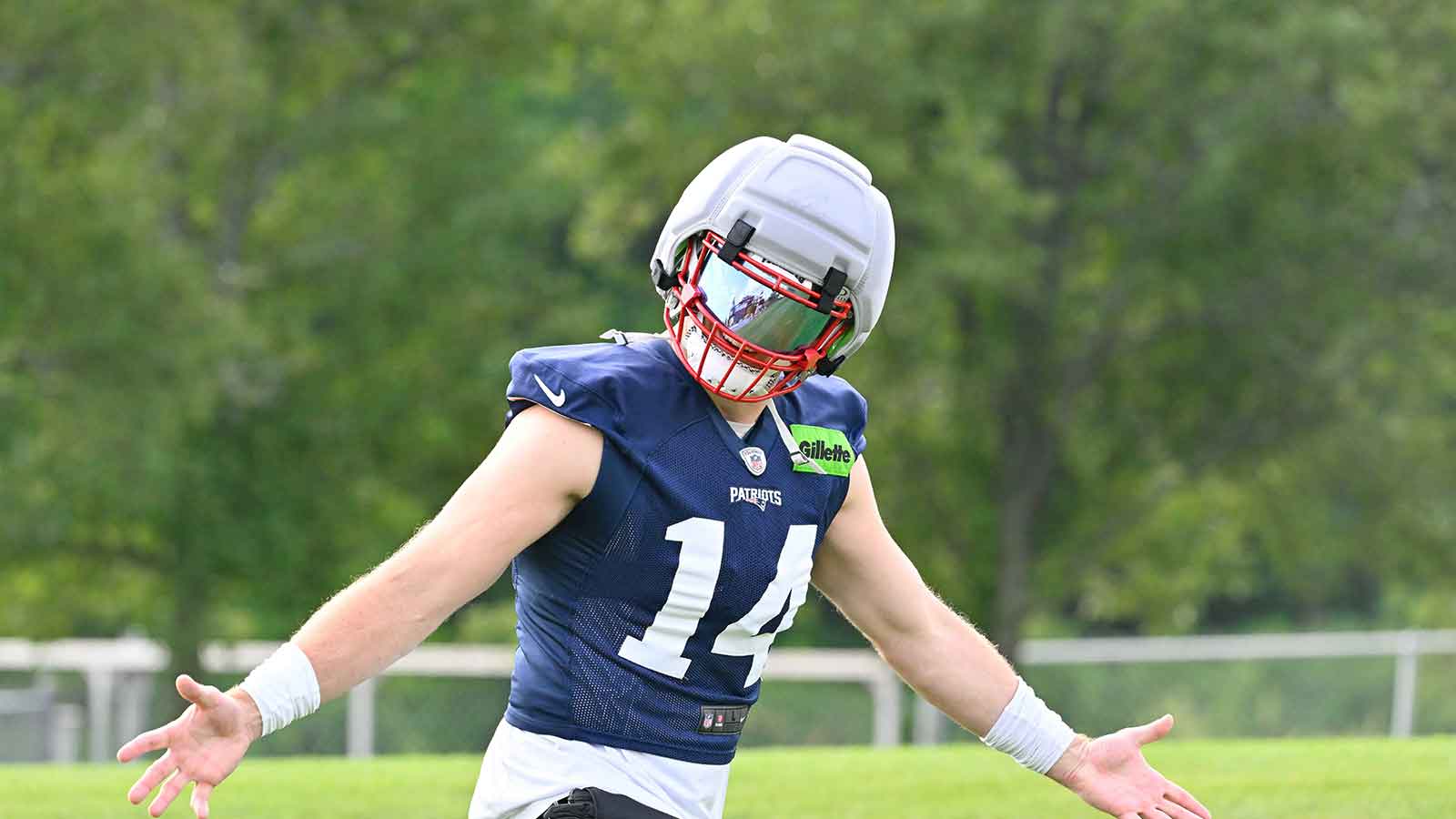 New England Patriots linebacker Robert Spillane (14) walks to practice for training camp at Gillette Stadium. 