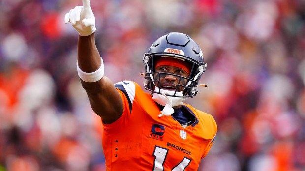 Denver Broncos wide receiver Courtland Sutton (14) reacts after catching a touchdown pass against the New England Patriots during the first half in the 2026 AFC Championship Game at Empower Field at Mile High