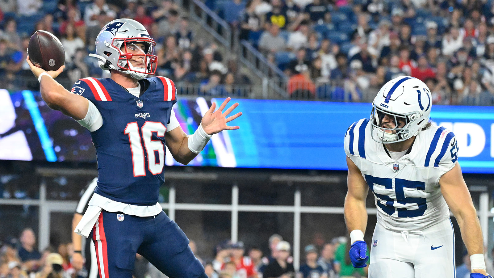 New England Patriots quarterback Tommy DeVito (16) throws a pass against Indianapolis Colts defensive end Caden Curry (55) during the first half at Gillette Stadium.