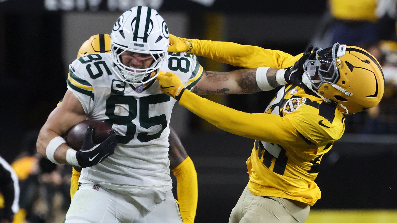 Green Bay Packers tight end Tucker Kraft (85) stiff arms Pittsburgh Steelers safety Juan Thornhill (22) during the third quarter at Acrisure Stadium