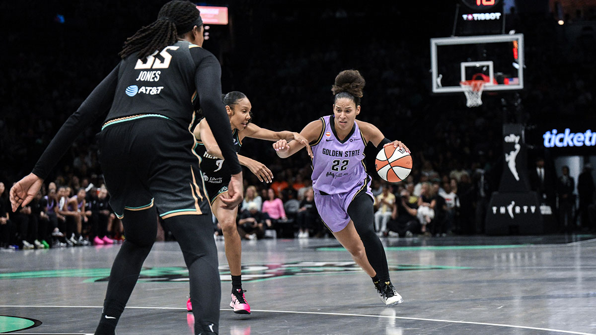 Aug 27, 2026; Brooklyn, New York, USA; Golden State Valkyries guard Veronica Burton (22) drives past New York Liberty guard Rebekah Gardner (7) during the first half at Barclays Center. Mandatory Credit: John Jones-Imagn Images