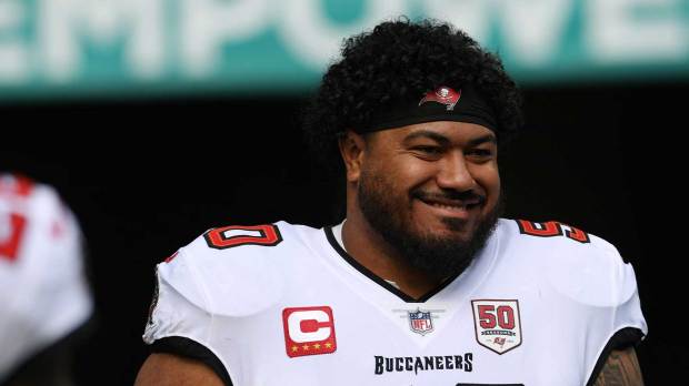 Tampa Bay Buccaneers defensive tackle Vita Vea (50) walks out for player introductions prior to a game against the Miami Dolphins at Hard Rock Stadium.