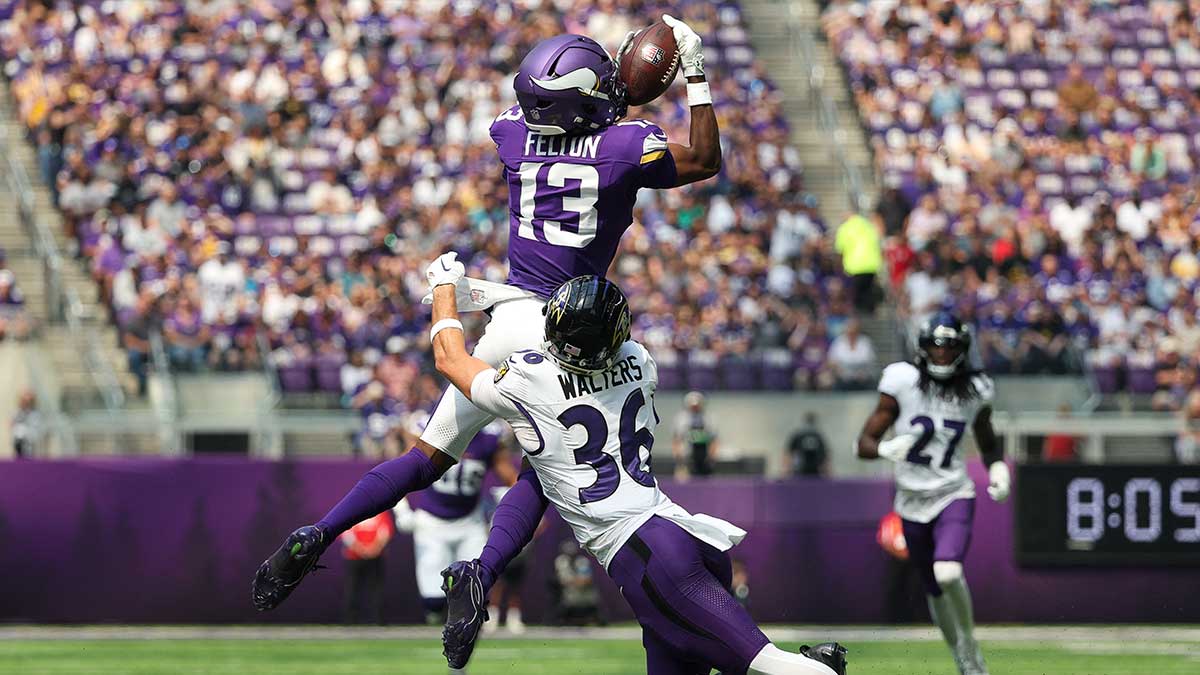 Minnesota Vikings wide receiver Tai Felton (13) catches a pass as Baltimore Ravens safety Silas Walters (36) defends during the first half at U.S. Bank Stadium. 
