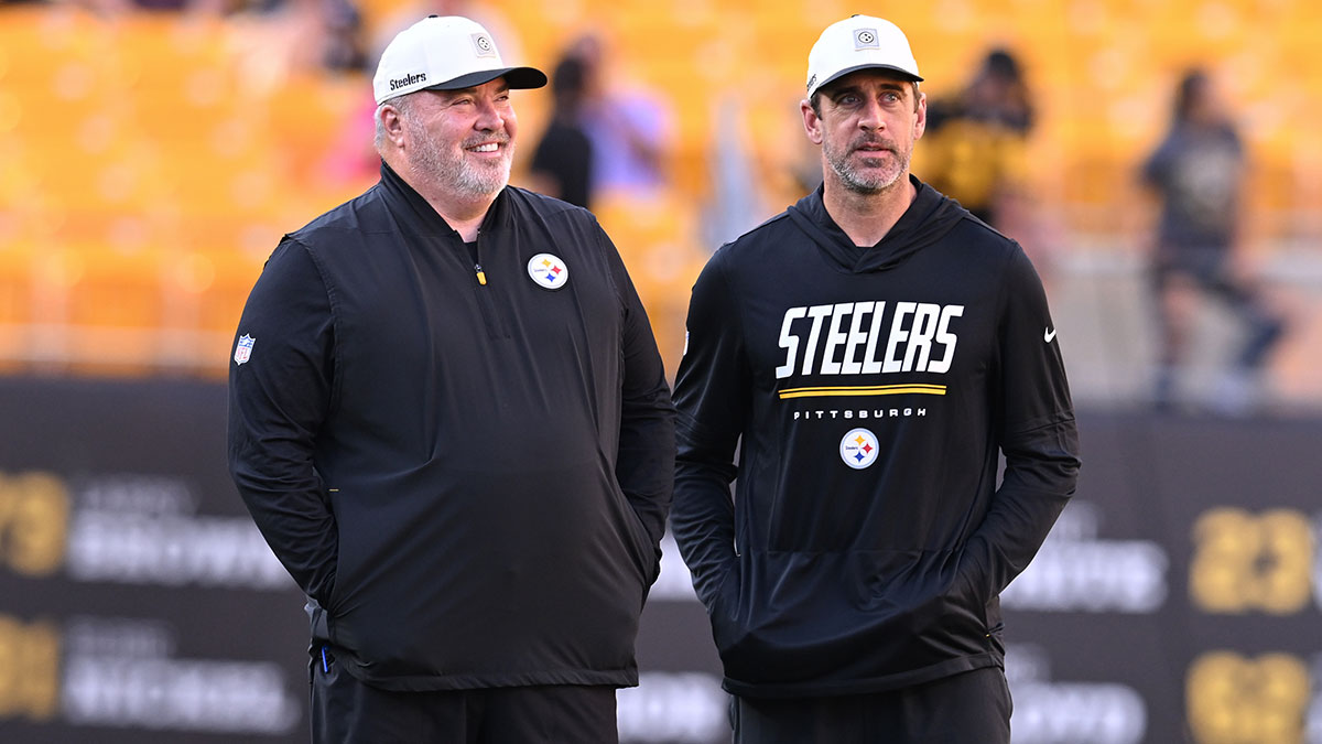 Pittsburgh Steelers head coach Mike McCarthy talks with quarterback Aaron Rodgers during warms up for a game against the New York Jets at Acrisure Stadium.