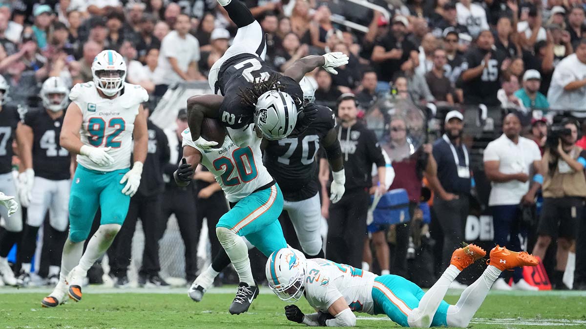 Las Vegas Raiders running back Ashton Jeanty (2) is flipped by Miami Dolphins safety Zayne Anderson (23) in the third quarter at Allegiant Stadium