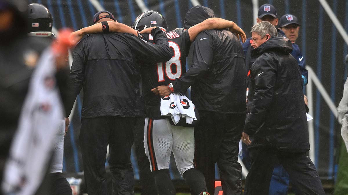 Sep 20, 2026; Chicago, Illinois, USA; Chicago Bears quarterback Caleb Williams (18) is helped off the field with an apparent injury against the Minnesota Vikings during the second half at Soldier Field.